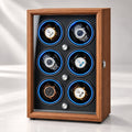 Coffret 6 montres en bois, trois rangées de deux berceaux éclairés, porte vitrée fermée.